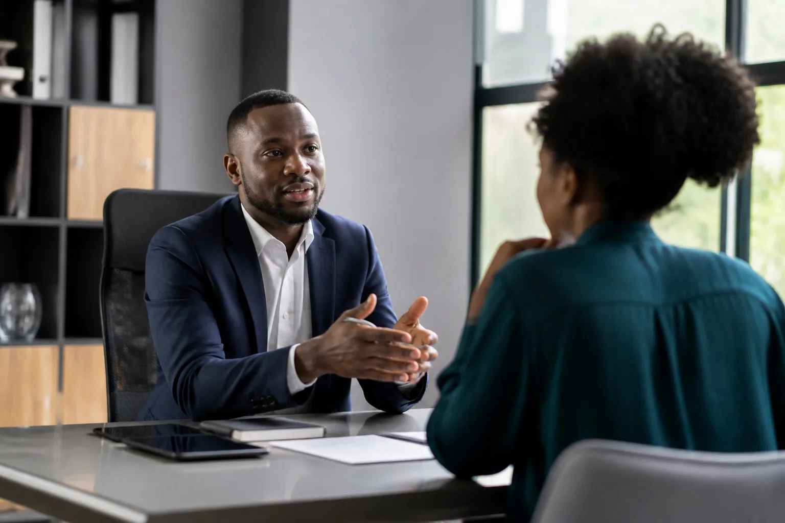 Professional meeting a client in a South African office — public liability versus professional indemnity insurance